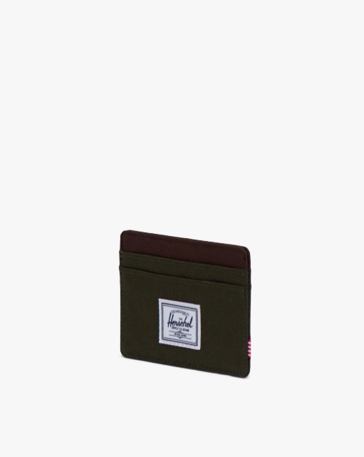 Green cardholder with a Herschel logo on a white background