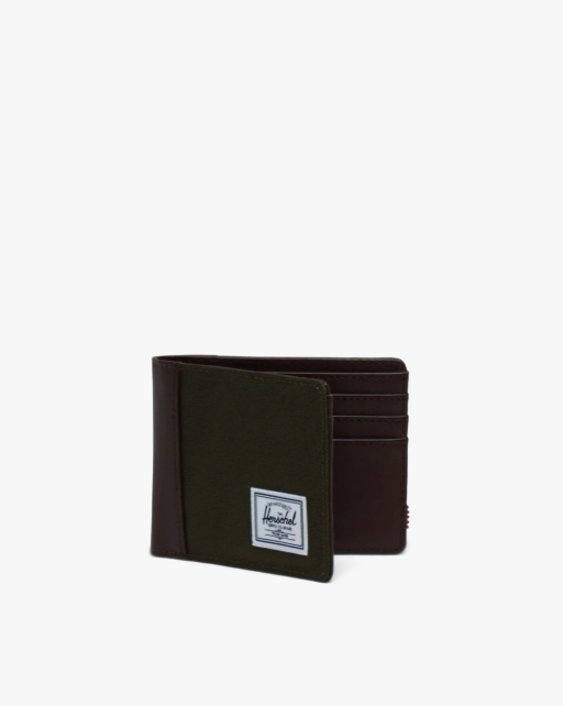 Open green wallet with brown spine and a Herschel logo on a white background