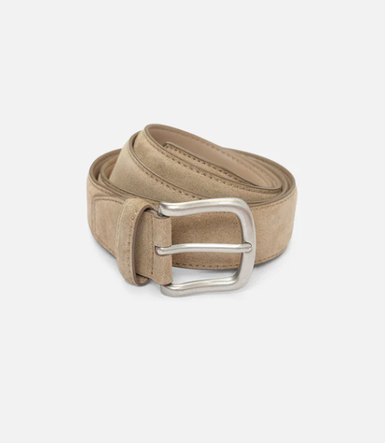 Beige belt with a silver buckle on a light gray background