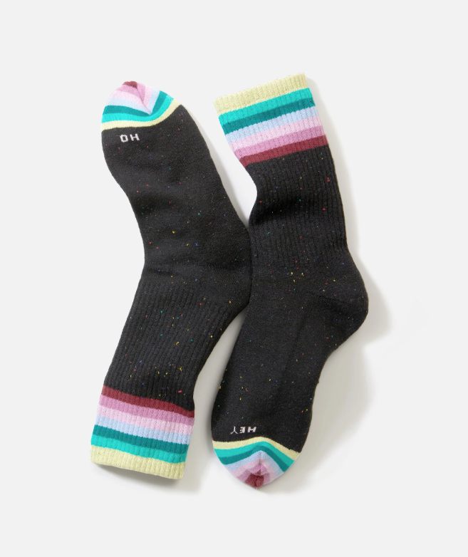 Black socks with colorful striped cuffs on a white background