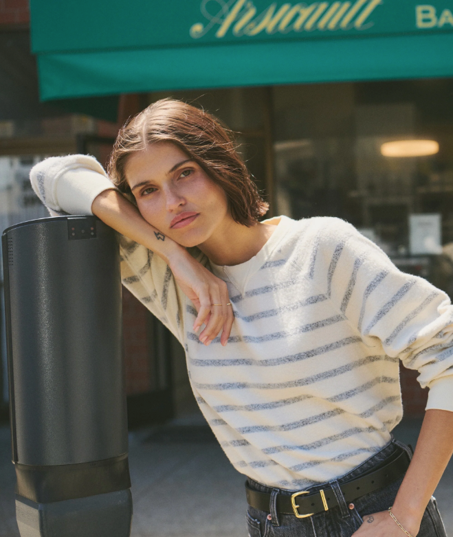 Woman in a black and white striped sweater.