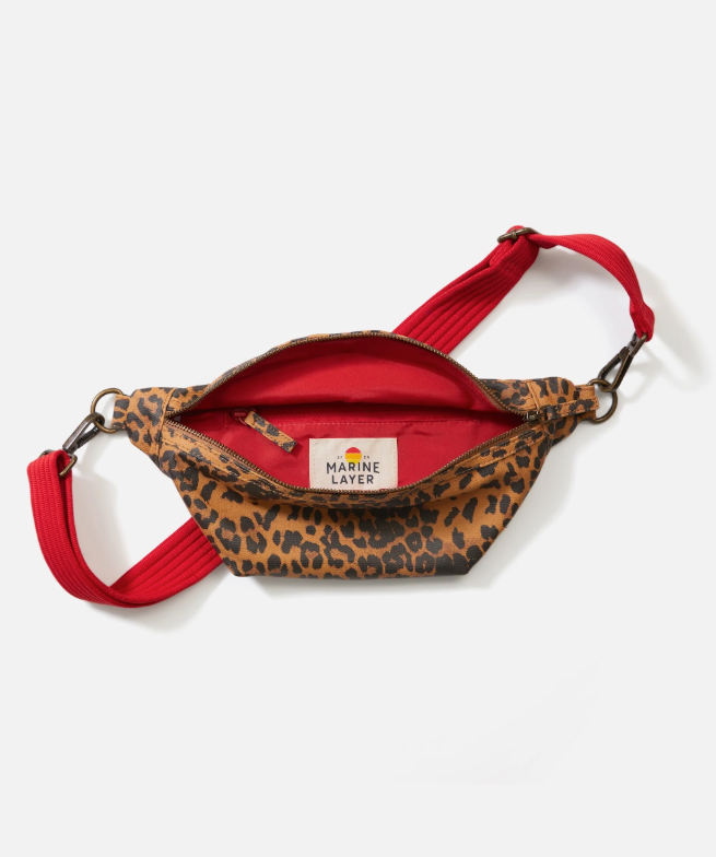 Leopard print fanny pack with red strap on a white background