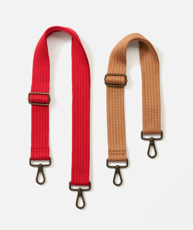 Red and brown bag straps with metal buckles on a white background