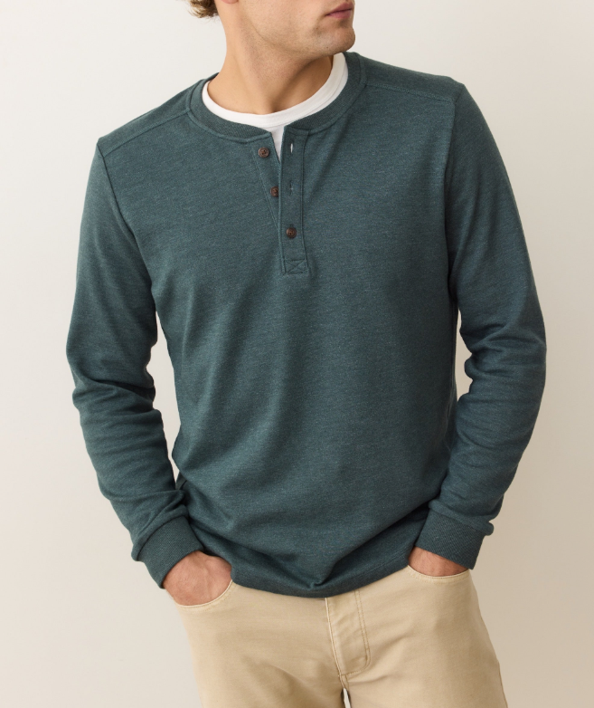 Man wearing a green henley on a white background