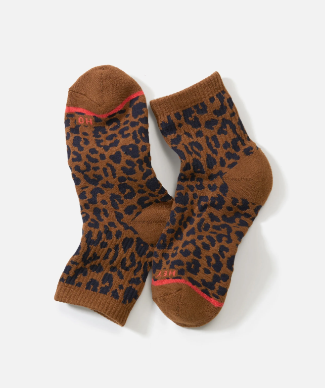 Pair of cheetah print crew socks on a white background