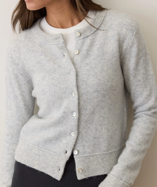 Gray cardigan worn by a person against a neutral background