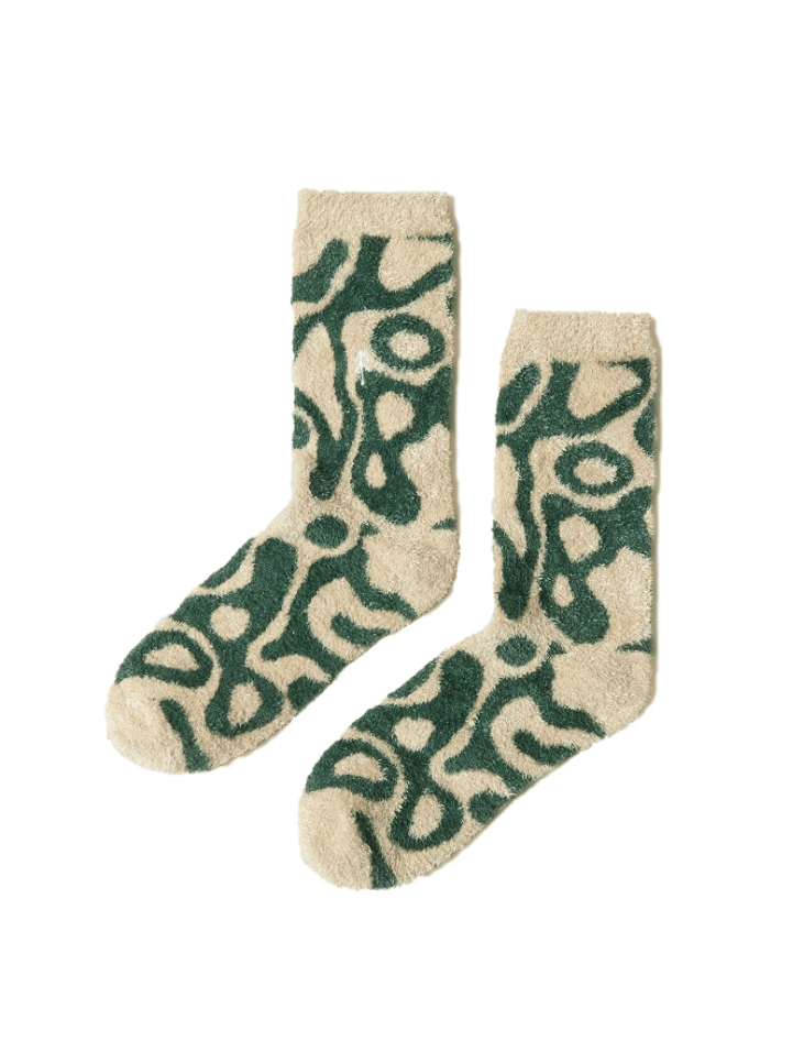 Pair of socks with green abstract pattern on a beige background