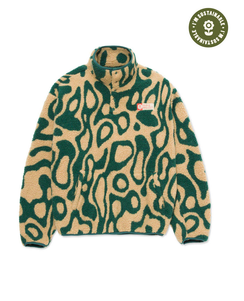 Green and yellow patterned sweater on a white background
