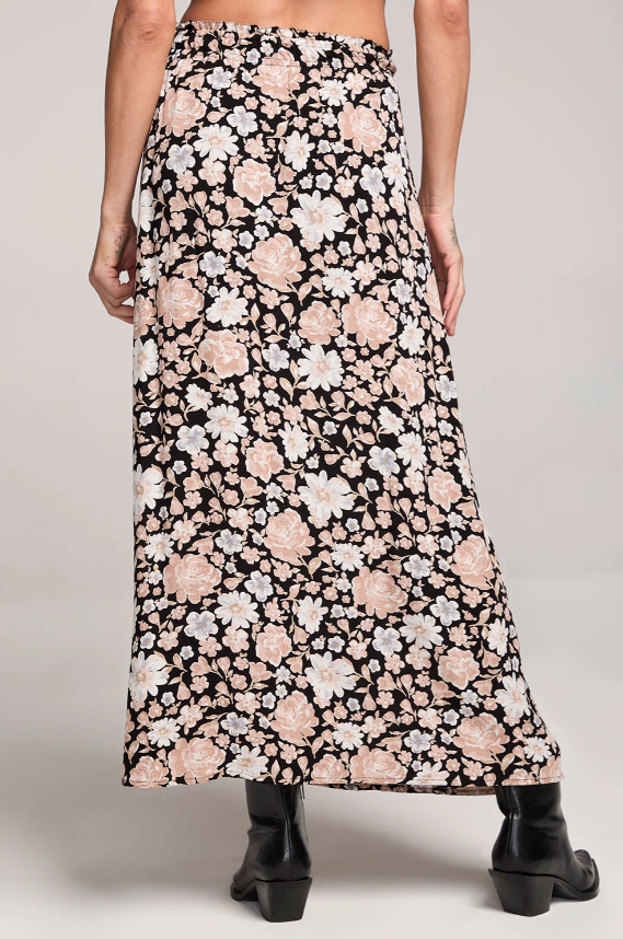 Floral patterned midi skirt worn by a person on a plain background
