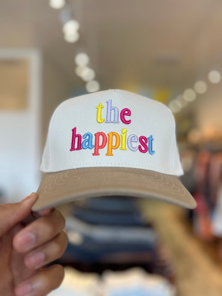 White hat with brown bill and embroidered text.