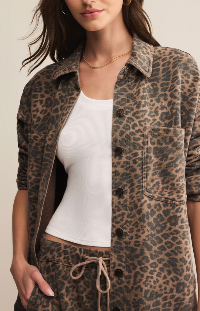 Woman wearing a leopard print jacket over a white top