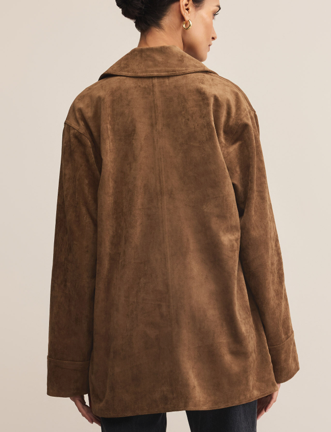 Brown faux suede jacket worn by a person on a plain background